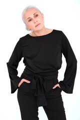 Aged mature woman in black suit on white background with smooth healthy skin face. Beautiful aging mature woman with blonde hair and happy smiling touching face. 