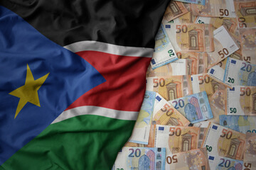 colorful waving national flag of south sudan on a euro money background. finance concept