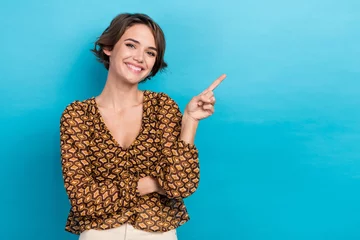 Fotobehang Photo portrait of charming lady wear old school retro blouse point finger empty space cheap stock market isolated on blue color background © deagreez