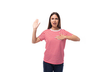 a pretty young caucasian woman with dark straight hair in glasses and in a striped red t-shirt gestures with her hands on a white background