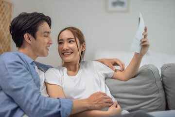 Asian couples joyfully watch ultrasounds, revealing baby's health, gender, strengthening family bonds