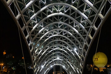 Fragment of pedestrian bridge over Kura River - Bridge of Peace at night. TBILISI, GEORGIA. © dbrnjhrj
