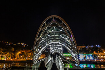 Fragment of pedestrian bridge over Kura River - Bridge of Peace at night. TBILISI, GEORGIA. © dbrnjhrj