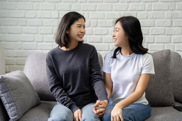 Happy asian lesbian couple, LGBTQ showing love and romance together at home.