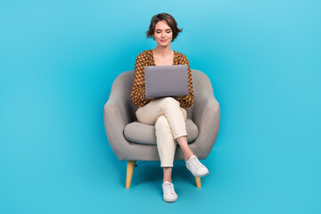 Full size photo of lovely successful girl sit comfy chair use wireless netbook isolated on blue...