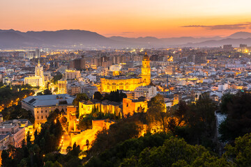 Naklejka premium Malaga skyline, Spain cityscape with Cathedral, City Hall and Alcazaba citadel of Malaga at dusk