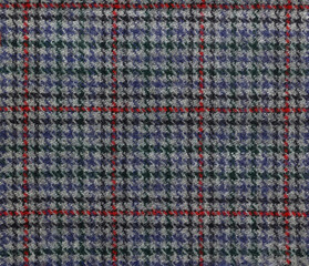 Houndstooth tartan pattern on a wool fabric in grey red and blue