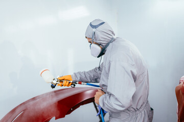 Automotive paint services, quality auto body shop concept. Authentic shot. Car painter repairman...