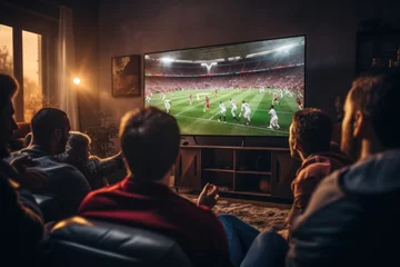 Fotobehang Group of friends watching a football match on TV © sirisakboakaew