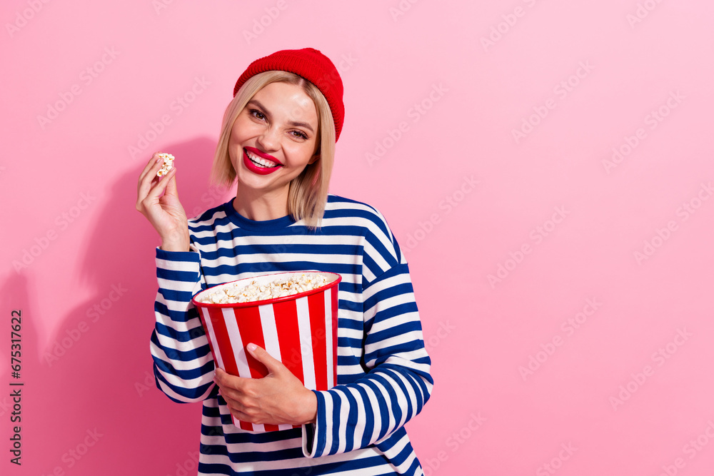 Canvas Prints Photo of cheerful pretty lady wear striped shirt enjoying film eating pop corn empty space isolated pink color background