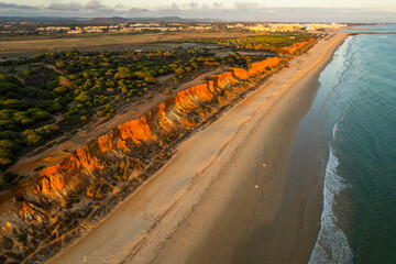 Praia da Falesia, Algarve beach in Albufeira, Portugal. Aerial drone view at sunset
