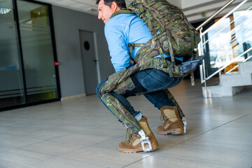 Mechanical military exoskeleton to help soldiers and military in their work, crouched back pose. Camouflage exoskeleton for futuristic high security