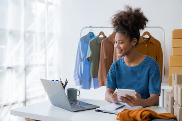 Startup entrepreneur small business SME young woman selling clothes online in home office, online...