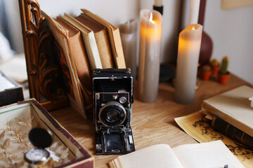 retro camera, books on wooden table, concept of genealogy, memory of ancestors,