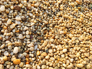 Stone background gravel. The rocky road. Fine pebbles. Construction material. The texture and pattern of the stones. Wallpaper with fine gravel. Frame, copy space and place for text
