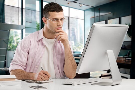 Young businessman using a computer in office, AI generated image