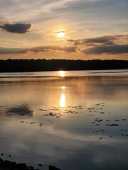 Beautiful warm orange sunset over the tranquil lake