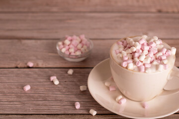 photo sweet dessert, white and pink marshmallow lies in a cup of coffee with foam, close-up, there is an empty space