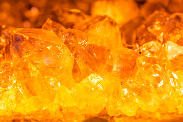 Golden crystal mineral stone. Gems. Mineral crystals in the natural environment. Texture of precious and semiprecious stones. Seamless background with copy space.