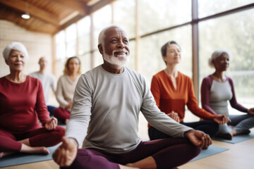 Fototapeta premium Group of active elderly people perform yoga together at a retreat center to improve their physical condition and well-being. Socialize with each other, active aging concept.