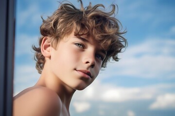 Portrait of a handsome boy with a sky background