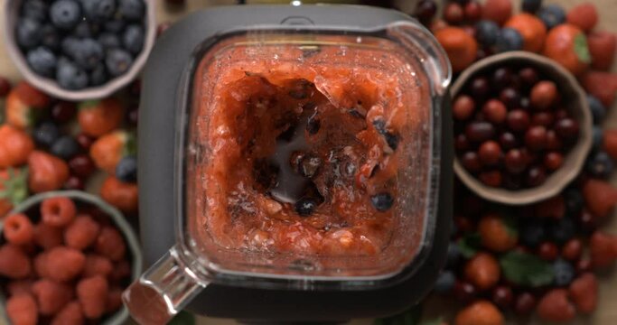 High-Speed Capture of Berries Blending in Slow-Motion for Healthy Smoothie, top view angle from above perspective