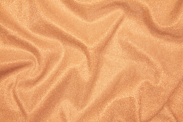 Trendy 80s, 90s, 2000s Background of draped light orange fabric with silver lurex thread. Beautiful...