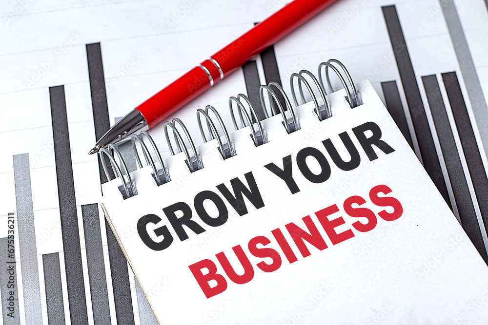 Poster grow your business text written on notebook with pen on chart