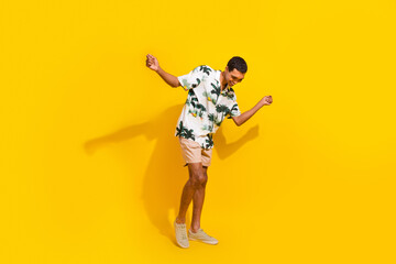 Full length photo of nice young male dance discotheque have fun wear trendy palms print garment isolated on yellow color background
