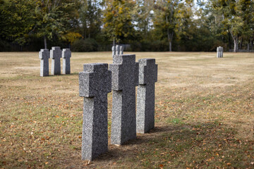 Naklejka premium Stone tombstones in the German cemetery in the fall. Beautiful German cemetery near Kyiv. Many dead German soldiers of the dead during the 2nd World War.