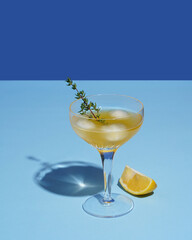 cocktail with lemon and ice, close-up, blue-blue background