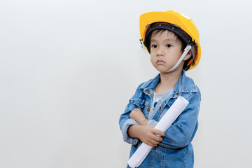Cute Asian thai happy kid wearing yellow construction helmet or safety hard hat, standing isolated on white background..