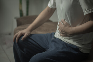 man having abdominal pain on white background