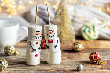 Happy marshmallow snowmen and Christmas winter holiday decorations.
