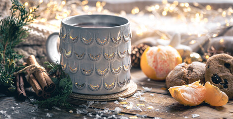 Winter composition with a cup of coffee, cinnamon and cookies.