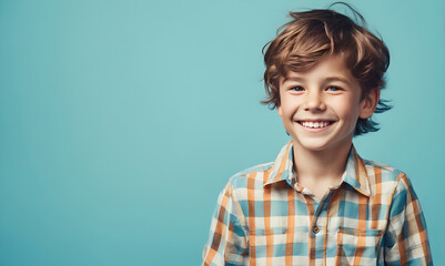 Excited smiling boy on solid color background - obrazy, fototapety, plakaty