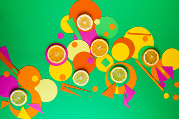 Suprematic colorful geometric shapes background with citrus fruits. Color blocking food and simple forms flat lay concept.