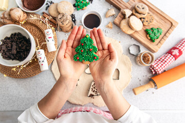 Gingerbread Christmas tree in female hands, close up.