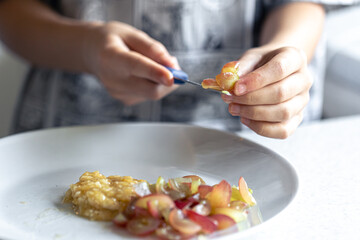 A woman cuts grapes on a cutting board.