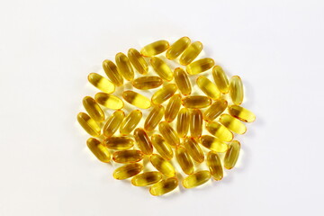 fish oil or linseed oil vitamin pills,gelatin capsule or tablet for health,heart health,medical,ayurvedic,phrmacy,naturopathy related concept in white background,top view,copy space