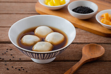 Glutinous rice balls filled with black sesame in sweet ginger soup