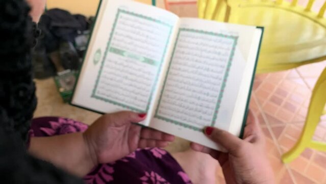 senior holding and recite the holy quran, blurred video 4k.