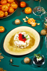 Close-up of plate with portioned Olivier salad on the New Year's table. Party in Russian style