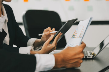 Close up of Business team analyzing income charts and graphs with modern laptop computer. Business analysis and strategy concept.