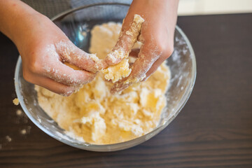 Creative Culinary Fun: Kid's Hands Crafting Raw Shortcrust for Mini Tarts