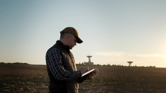 Man operator equipment tablet pc controls solar radio telescope antennas. Move camera