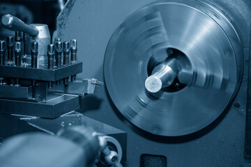 The lathe machine finish cut  metal shaft parts in the light blue scene.