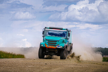racing truck high speed moving on terrain road during cross country rally