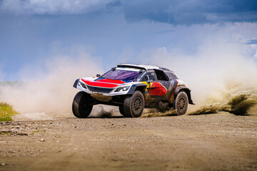 racing auto high speed moving on terrain road during cross country rally - Powered by Adobe
