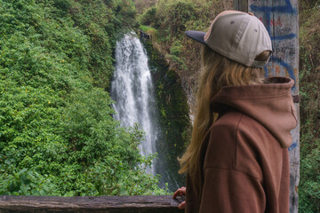 Woman looking at the waterfall 